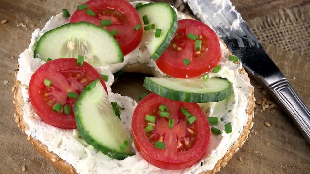 Rotating bun with Bagels with Cream Cheese and vegetables as not loopable 4K UHD footage