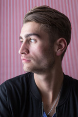 Fototapeta premium Portrait of an handsome young man with interesting background a