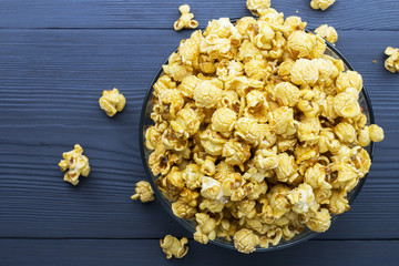 glass bowl with popcorn on blue wood table