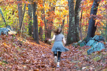 Girl Jogging in the Woods in Fall