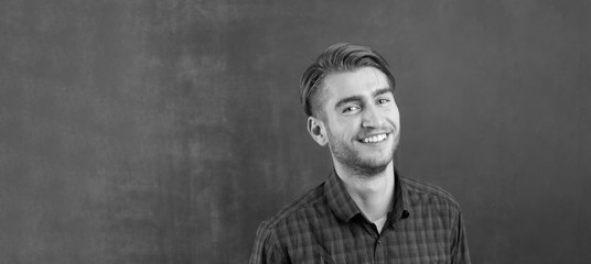 Portrait of a cheerful young man in checkered shirt
