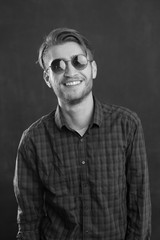 Portrait of a relaxed young man with checkered shirt and sunglas