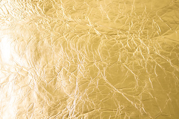 Gold wrinkled paper texture abstract background