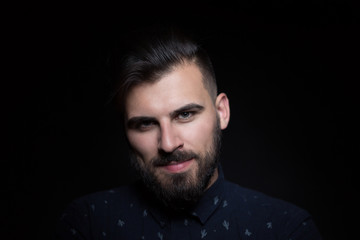 Portrait of the male over black background