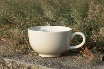 Coffee cup with small flower grass