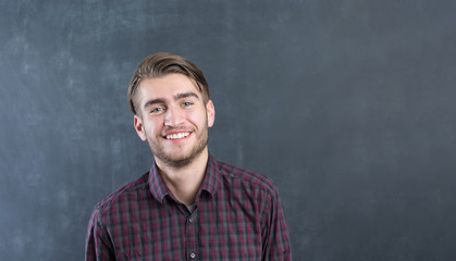 Portrait of a cheerful young man in checkered shirt
