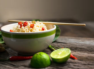 spicy Instant noodles with Vegetable in a bowl on wood board.