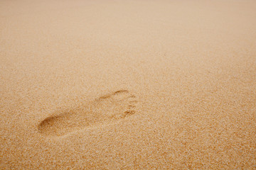 Fototapeta na wymiar Footprints on sand beach