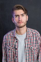 Portrait of a cheerful young man in checkered shirt