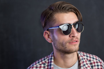 Obraz premium Portrait of a fashionable young man on dark background, chalkboa