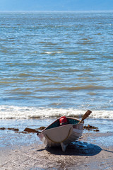 Fototapeta na wymiar lonely, wooden, old boat on a beach