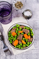 Meat stew with peas and carrots