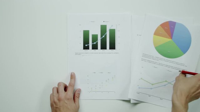 Man holding graphic charts.