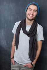 Portrait of a fashionable young man on dark background, chalkboa