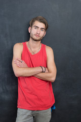 Portrait of a fashionable young man on dark background, chalkboa