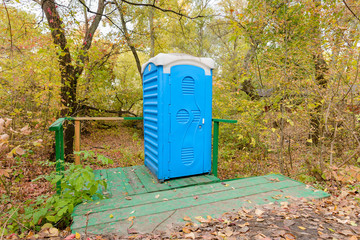 Blue Chemical Toilet in the Woods