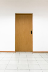 Wooden door on a clean wall indoors