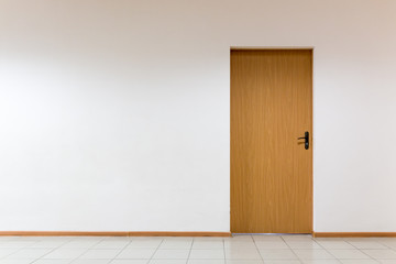 Wooden door on a clean wall indoors