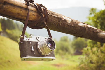 Old retro camera on the background of the Carpathian Mountains