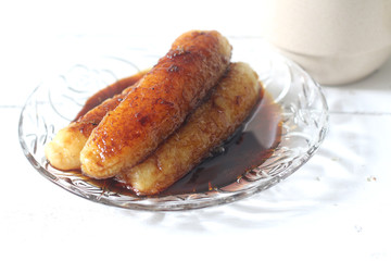 Banana fritters in melted palm sugar 
