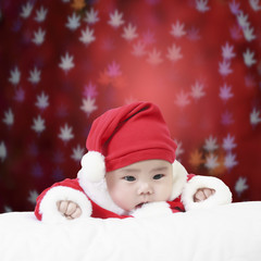 cheerful child wearing santa claus suit and something stare in s