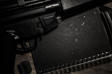 black notebook and weapon 