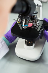 Scientist hands with microscope close-up shot in the laboratory