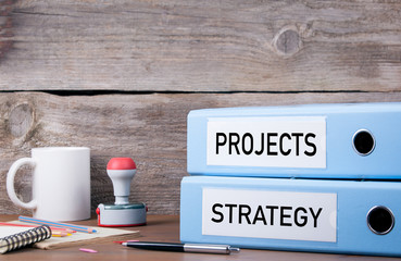 Projects and Strategy. Two binders on desk in the office. Busine