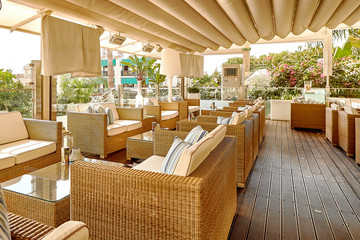 Soft sofas and tables in the beach cafe terrace.