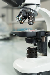 Scientist hands with microscope close-up shot in the laboratory