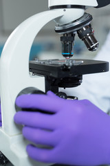 Scientist hands with microscope close-up shot in the laboratory