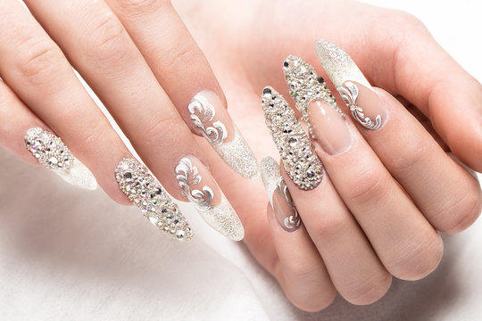 Fototapeta Beautifil wedding manicure for the bride in gentle tones with rhinestone. Nail Design. Close-up.