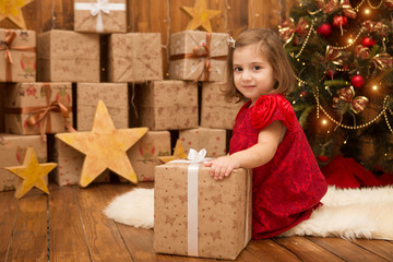 Fototapeta na wymiar Happy little girl with Christmas gifts