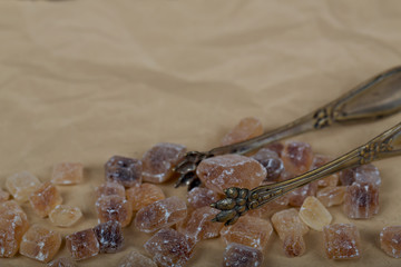 Old spoons and brown sugar cubes with space for text