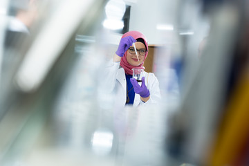 muslim lab worker with hijab or researcher doing an analysis in