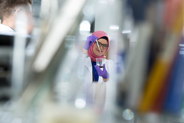 muslim lab worker with hijab or researcher doing an analysis in