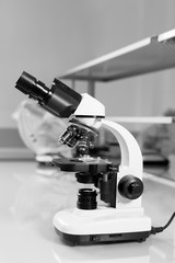 Scientist hands with microscope close-up shot in the laboratory