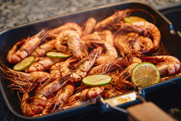 Cooking tiger prawns grilled with lemon. Close-up. Background.