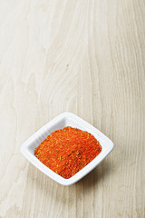 Red spice mixture on wood