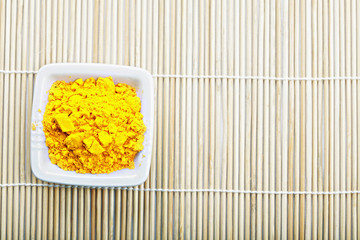 Saffron spice in white dish on mat