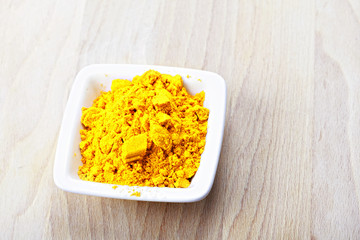 Saffron spice in white dish on wood