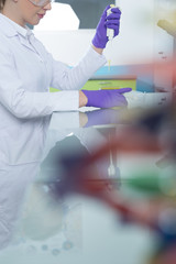 laboratory assistant analyzing a sample