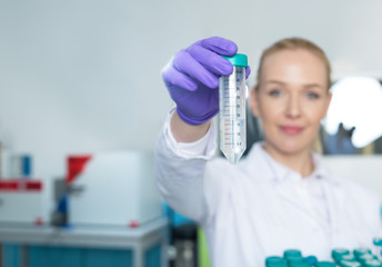 portrait of young woman scientist in lab analyzing liquid in ret