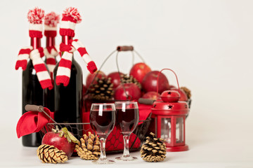 Merry Christmas and happy New year. Bottles of wine in a knitted