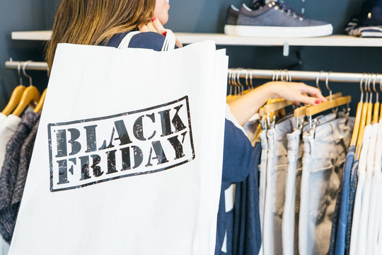 Woman Looking Through Clothing Rack