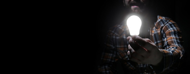 man in dark with glow bulb