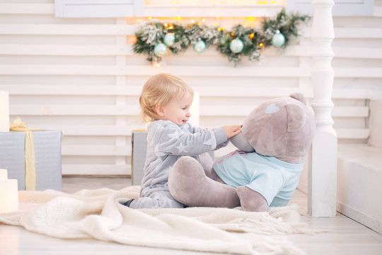Beautiful little baby boy in pajamas with stars celebrates Christmas