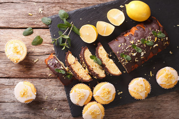 Lemon cake with chocolate and lemon muffins with frosting close-up. horizontal top view 