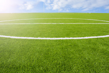 Obraz premium Artificial turf football field green on sky background