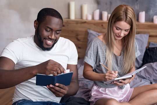 Happy couple making notes together